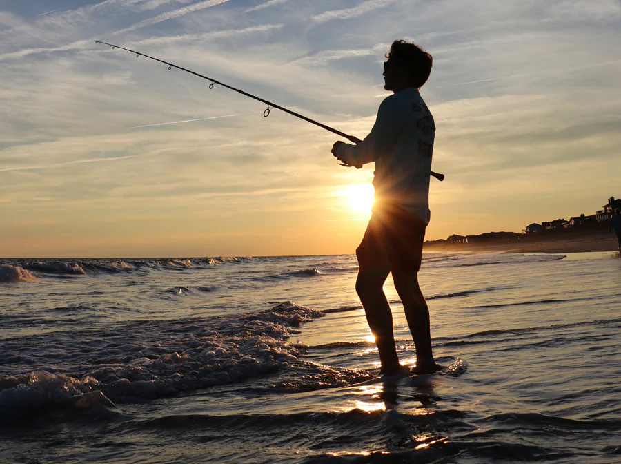 Professional angler fishing at sunrise